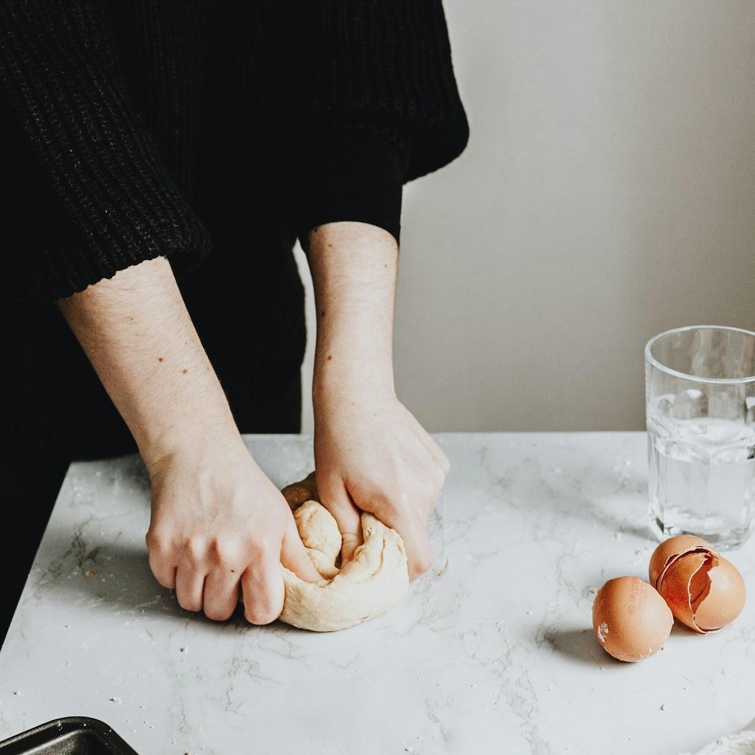 Community members collaborating in a contemporary kitchen, exchanging recipes and cooking techniques